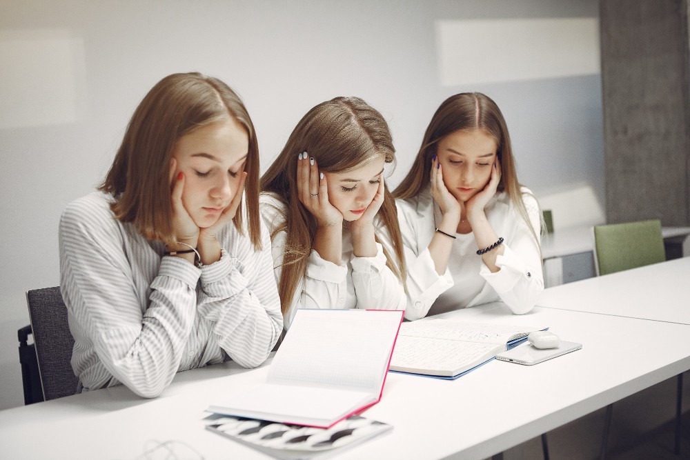 1701162000672-three-students-sitting-table-class-1751984002.jpg